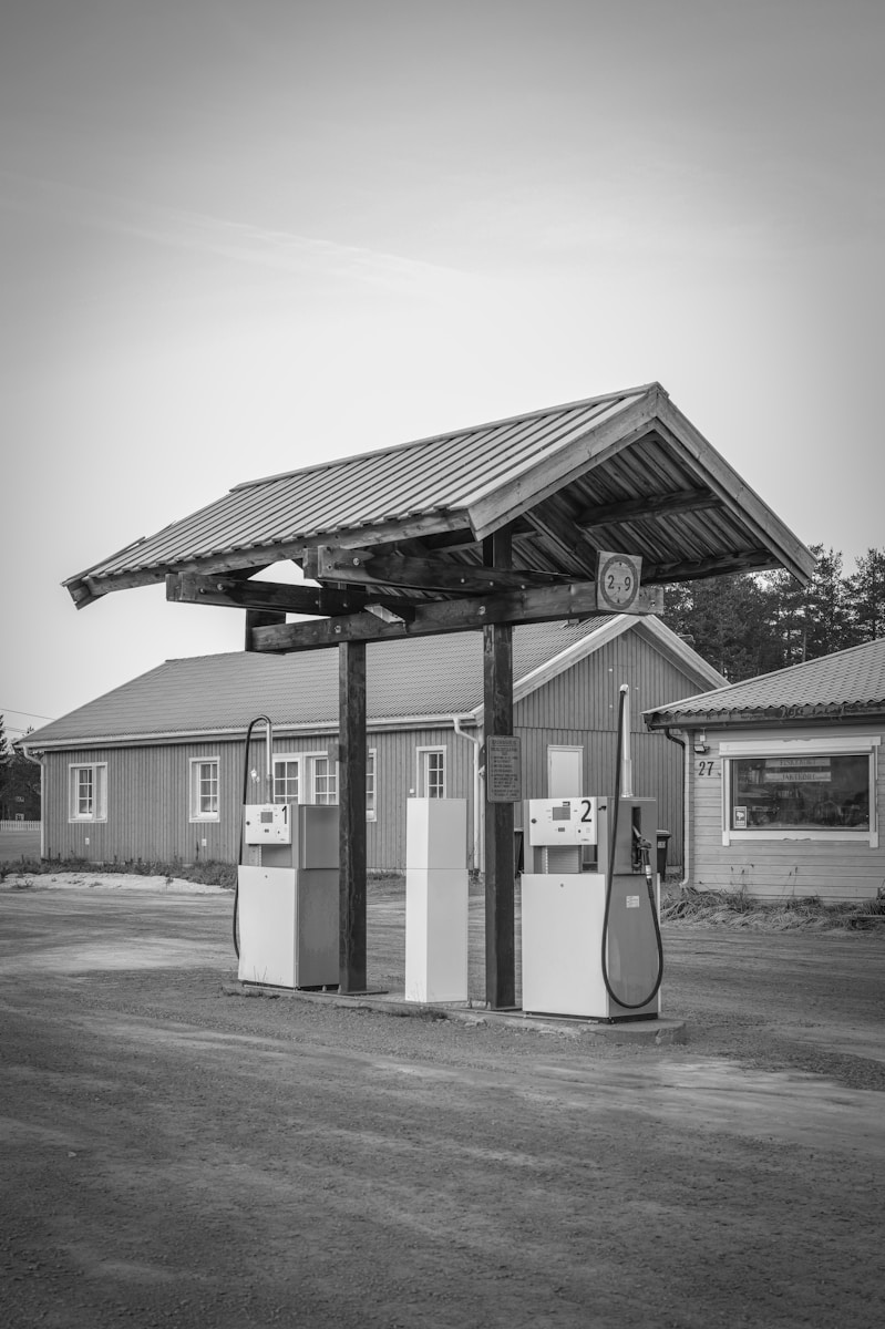Vintage gas pumps under a wooden roof